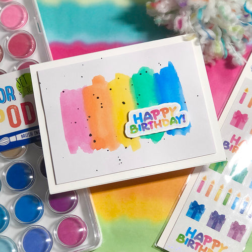 Colorful birthday card on top of arts and crafts supplies