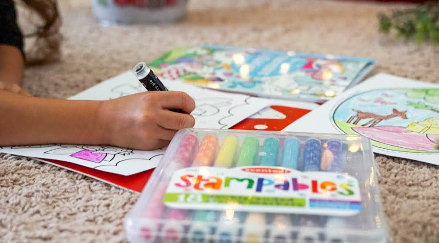 coloring book and markers on carpeted floor