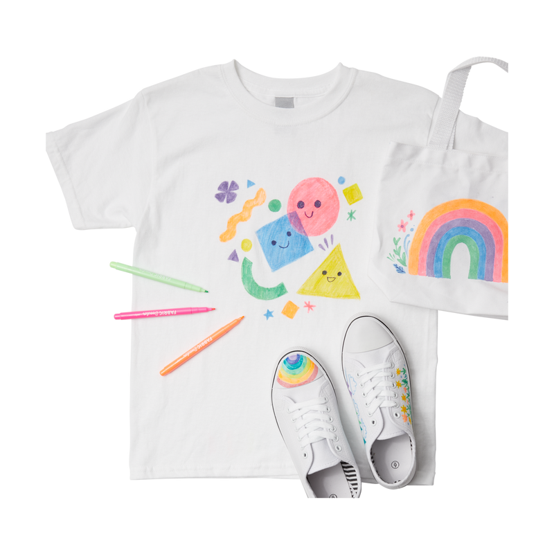 A white shirt, pair of shoes and canvas bag decorated with with cute and colorful designs from OOLY Fabric Doodlers markers.