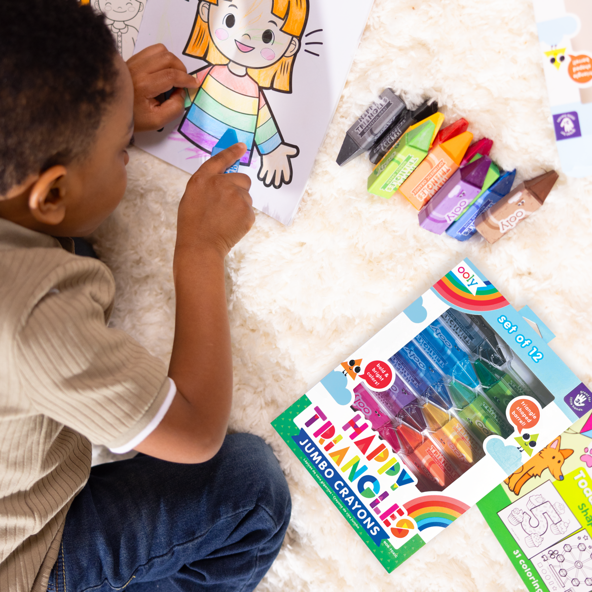 Kid coloring with Happy Triangles jumbo crayons