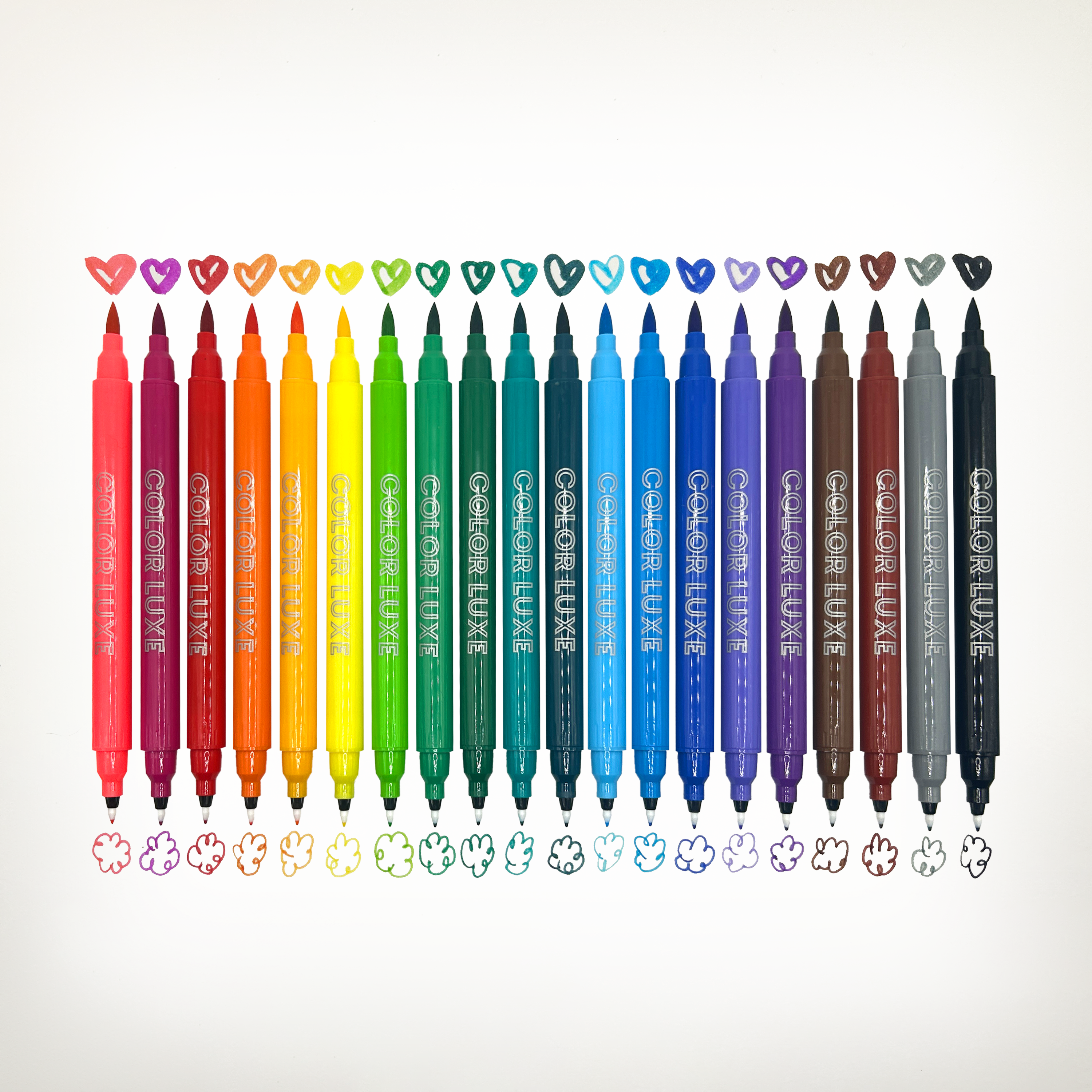 Row of uncapped OOLY Color Luxe Double-Ended Markers with colored heart and cloud swatches