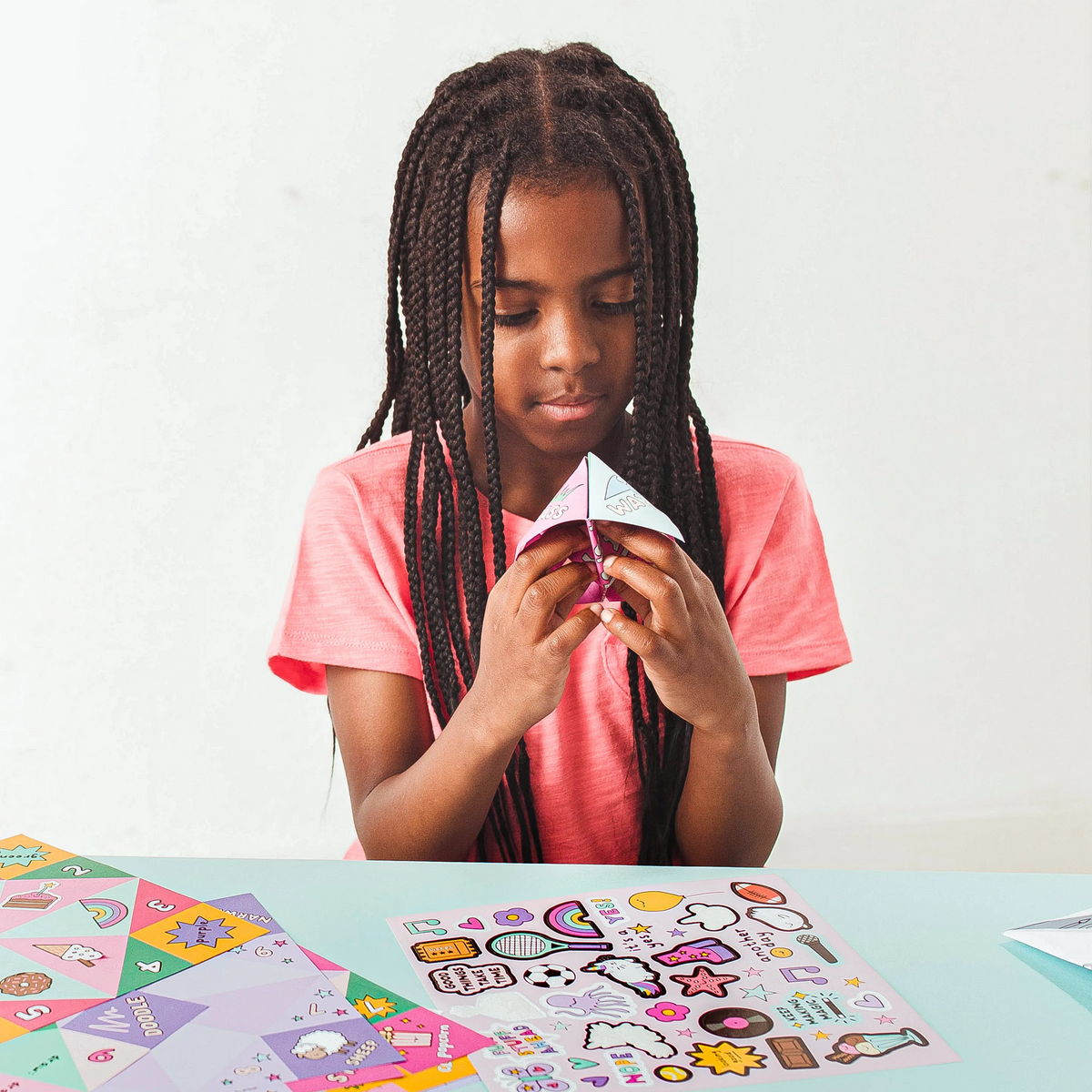 Girl playing with finished OOLY DIY Fortune Teller