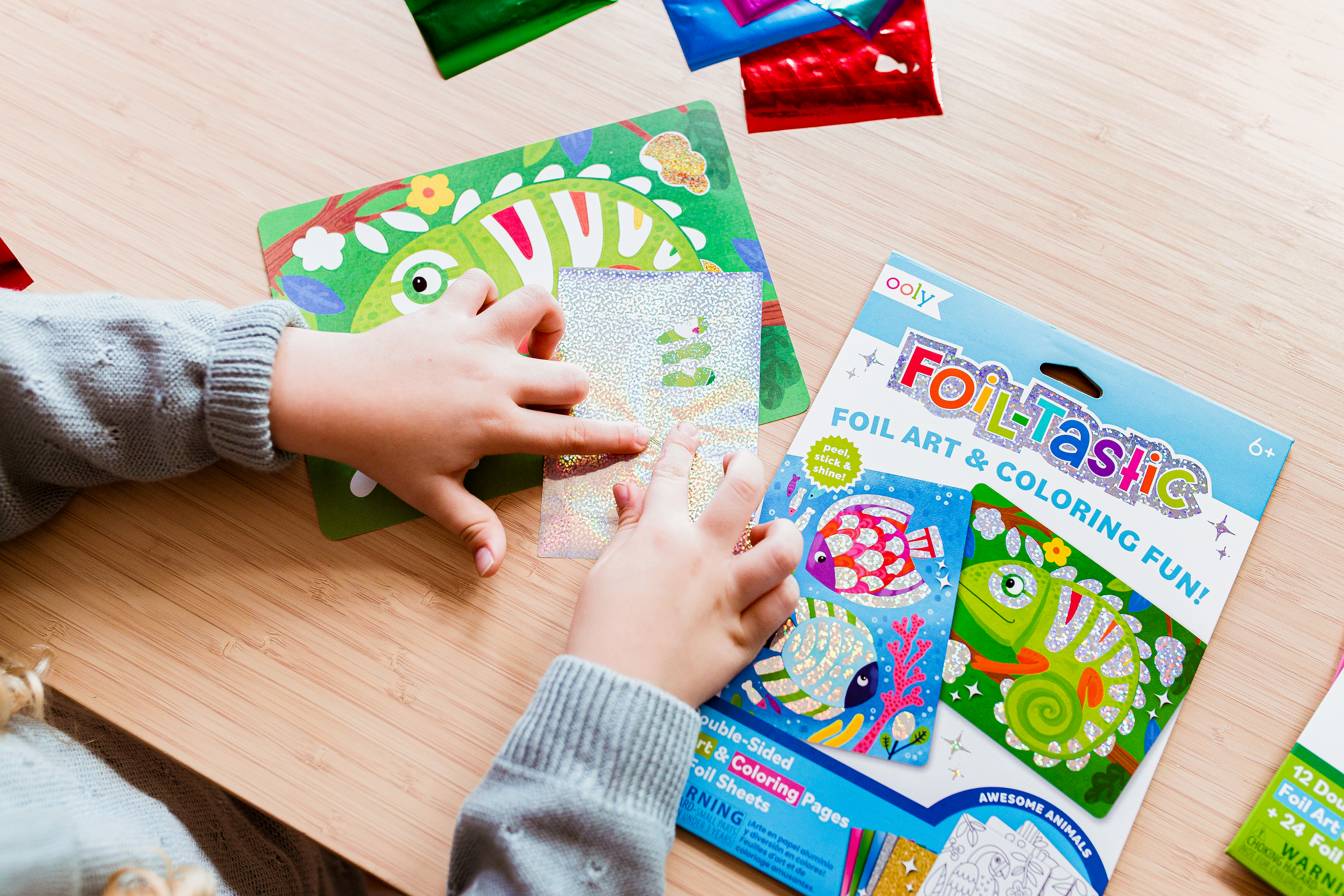 Kid pressing foil sheet from OOLY Foil-Tastic foil art set