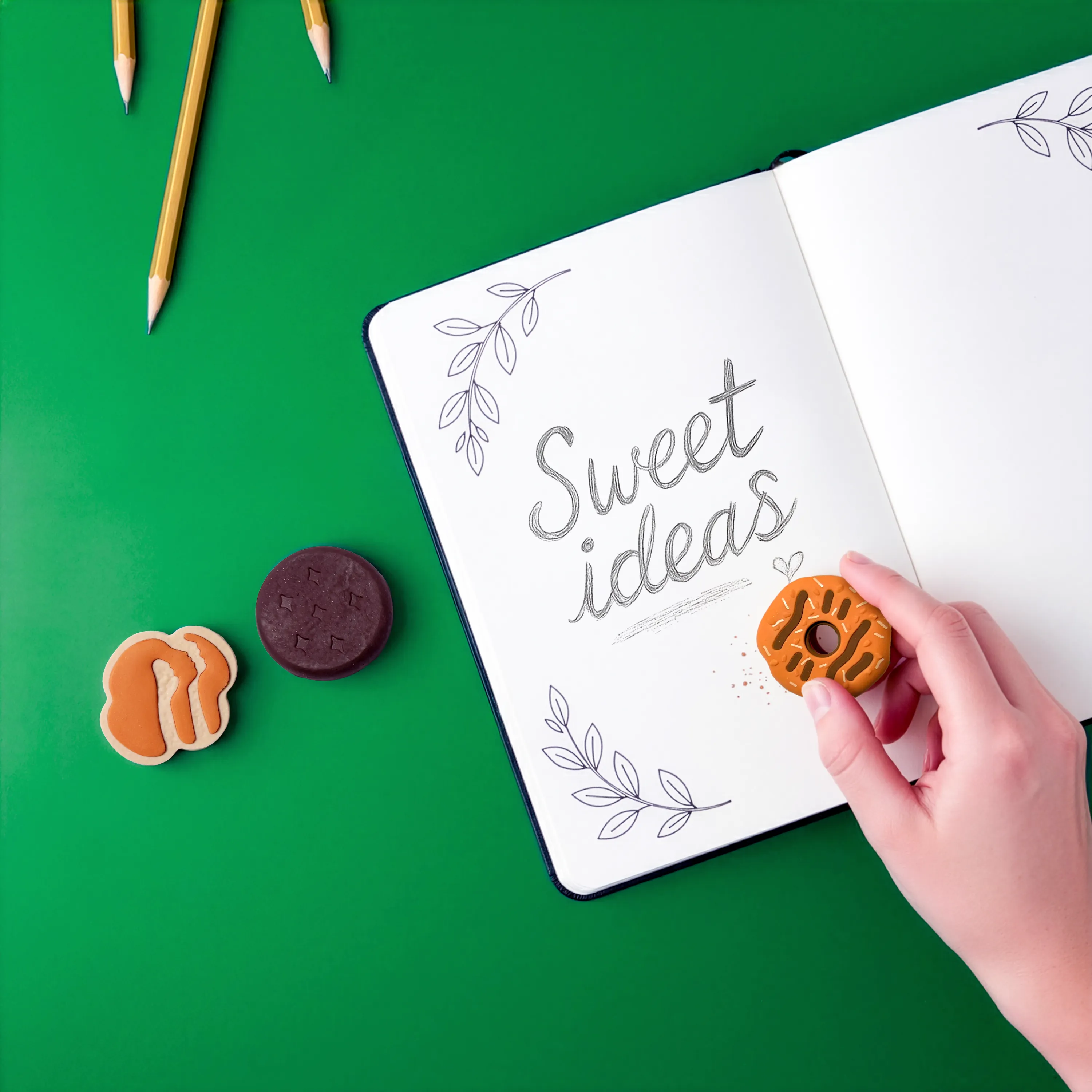 Person erasing in notebook that says "sweet ideas" with an OOLY x Girl Scouts Cookie Scented eraser