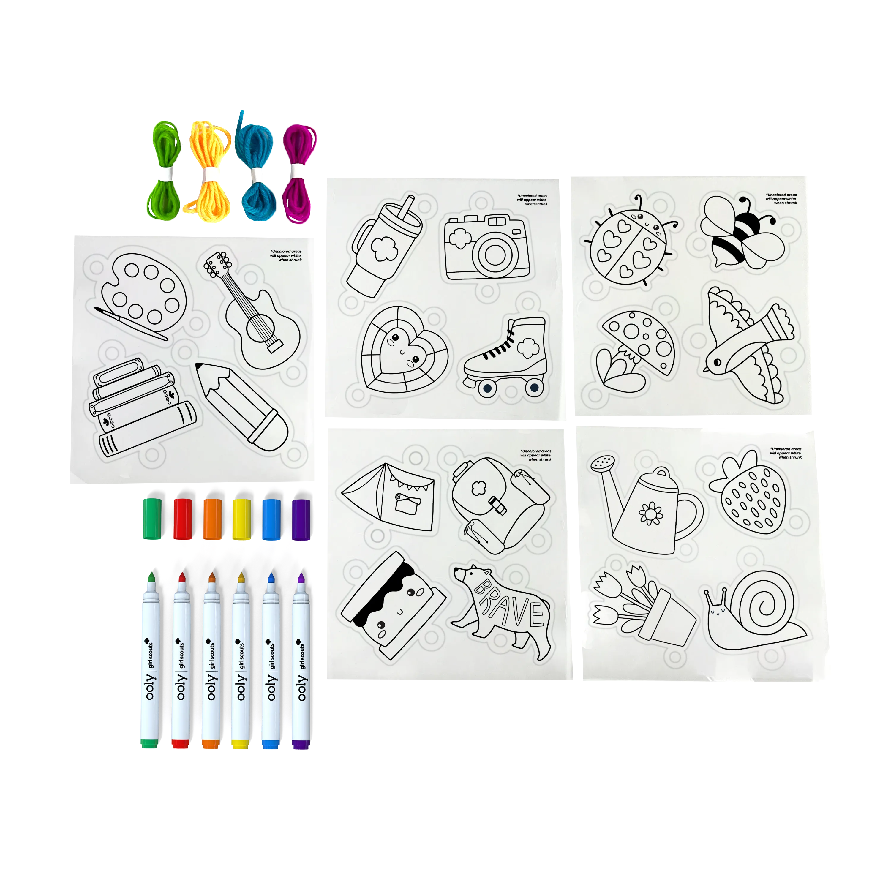 Contents of OOLY x Girl Scouts DIY Shrink Art Bracelet Kit including shrink charms, markers and cords.