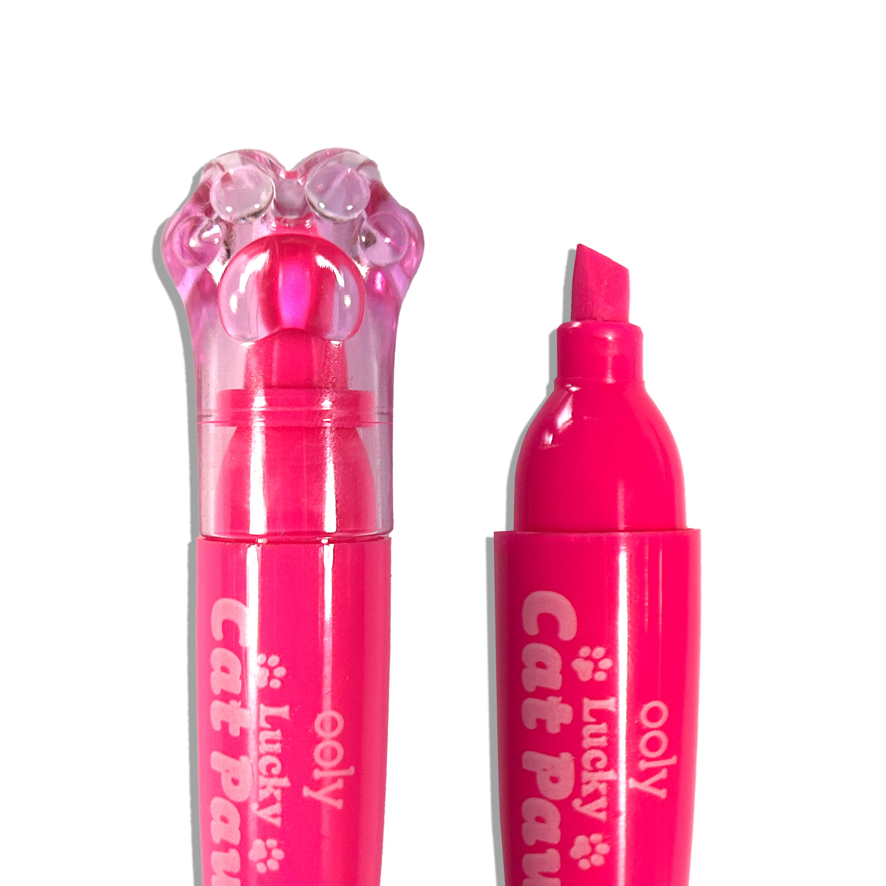 Close up of capped and uncapped pink OOLY Lucky Cat Paw Scented Neon Highlighters on a white background