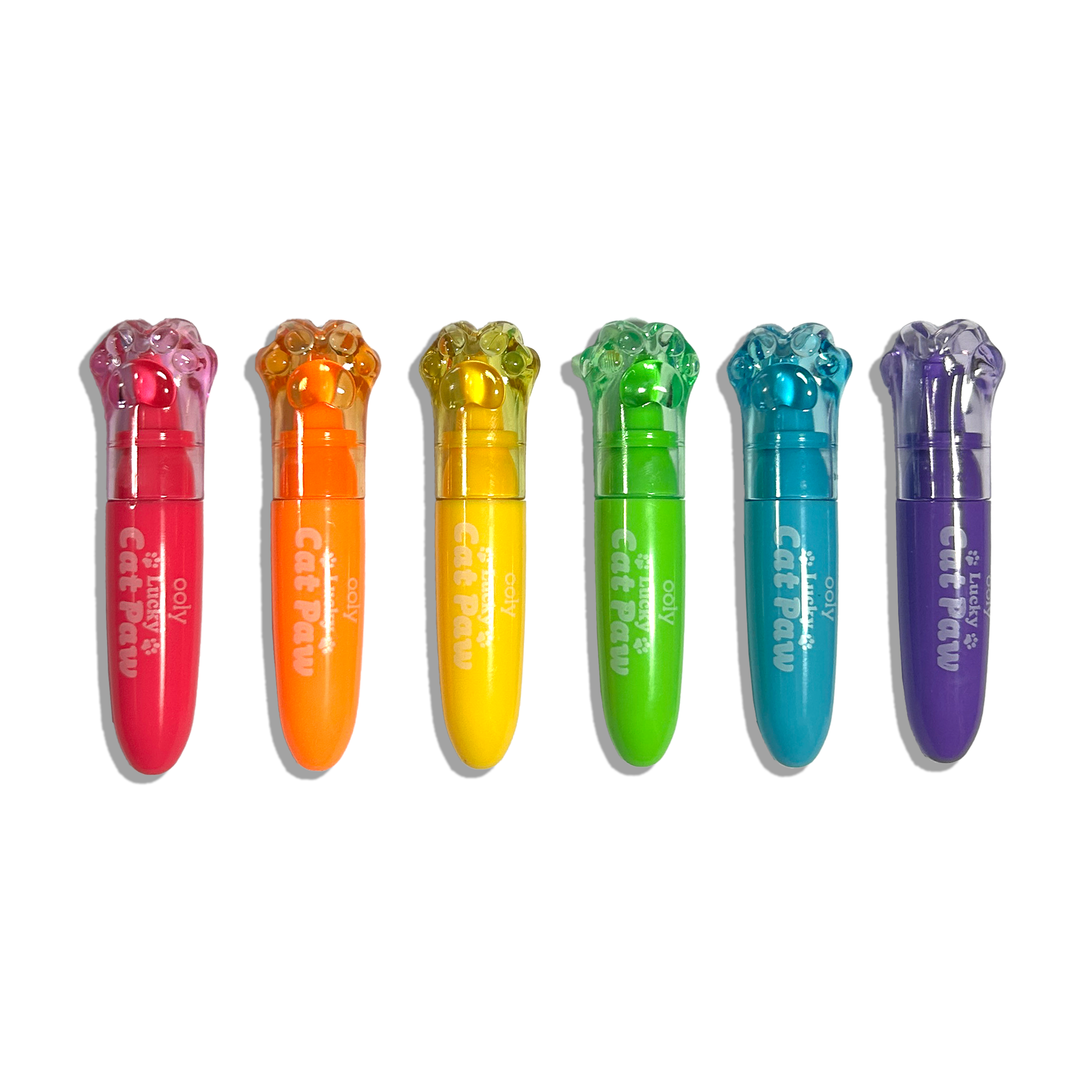 Row of capped OOLY Lucky Cat Paw Scented Neon Highlighters on a white background