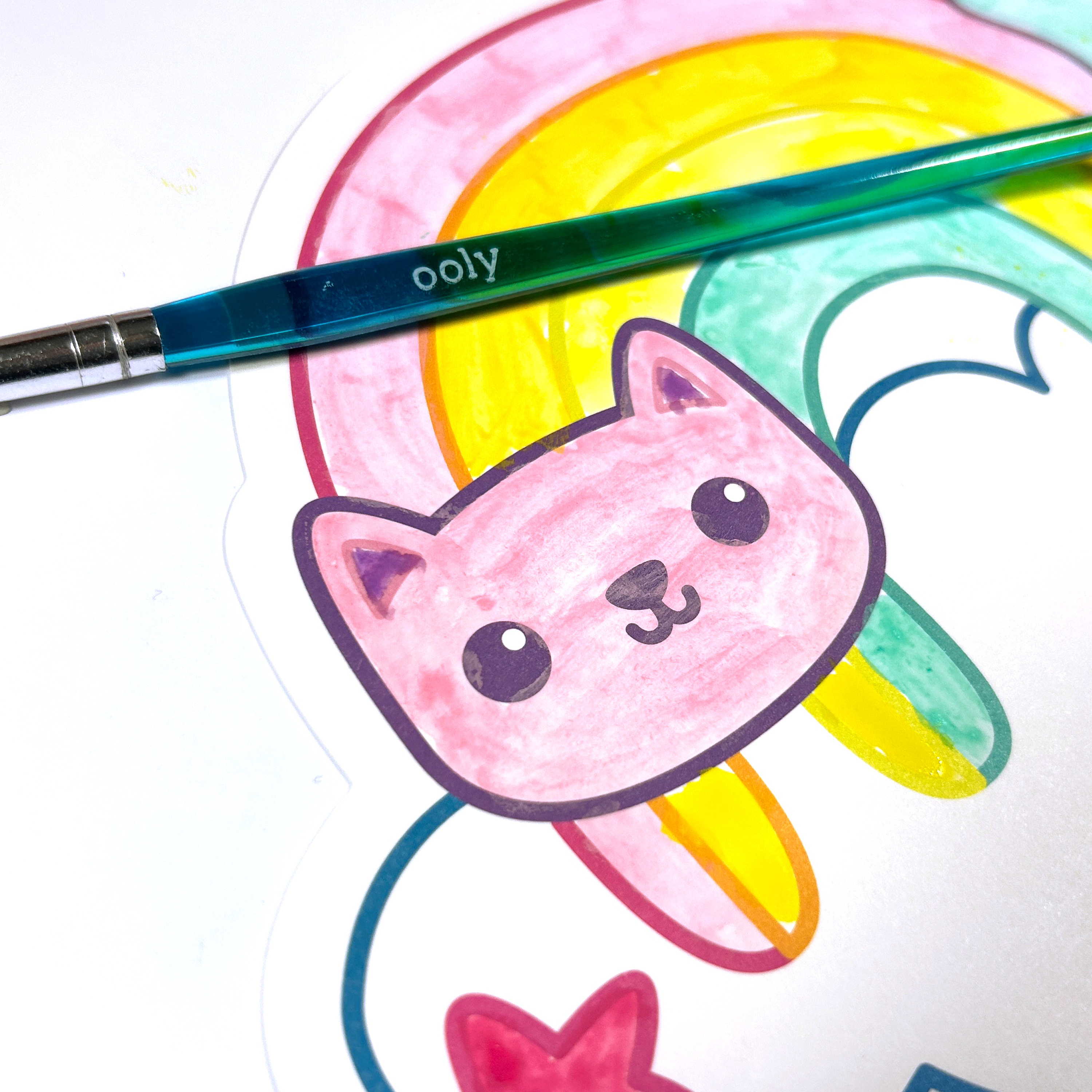 Close up of rainbow colored cat painted on a paint card from the OOLY Rainbow Cuties Playful Painters Easy Watercolor Painting Kit