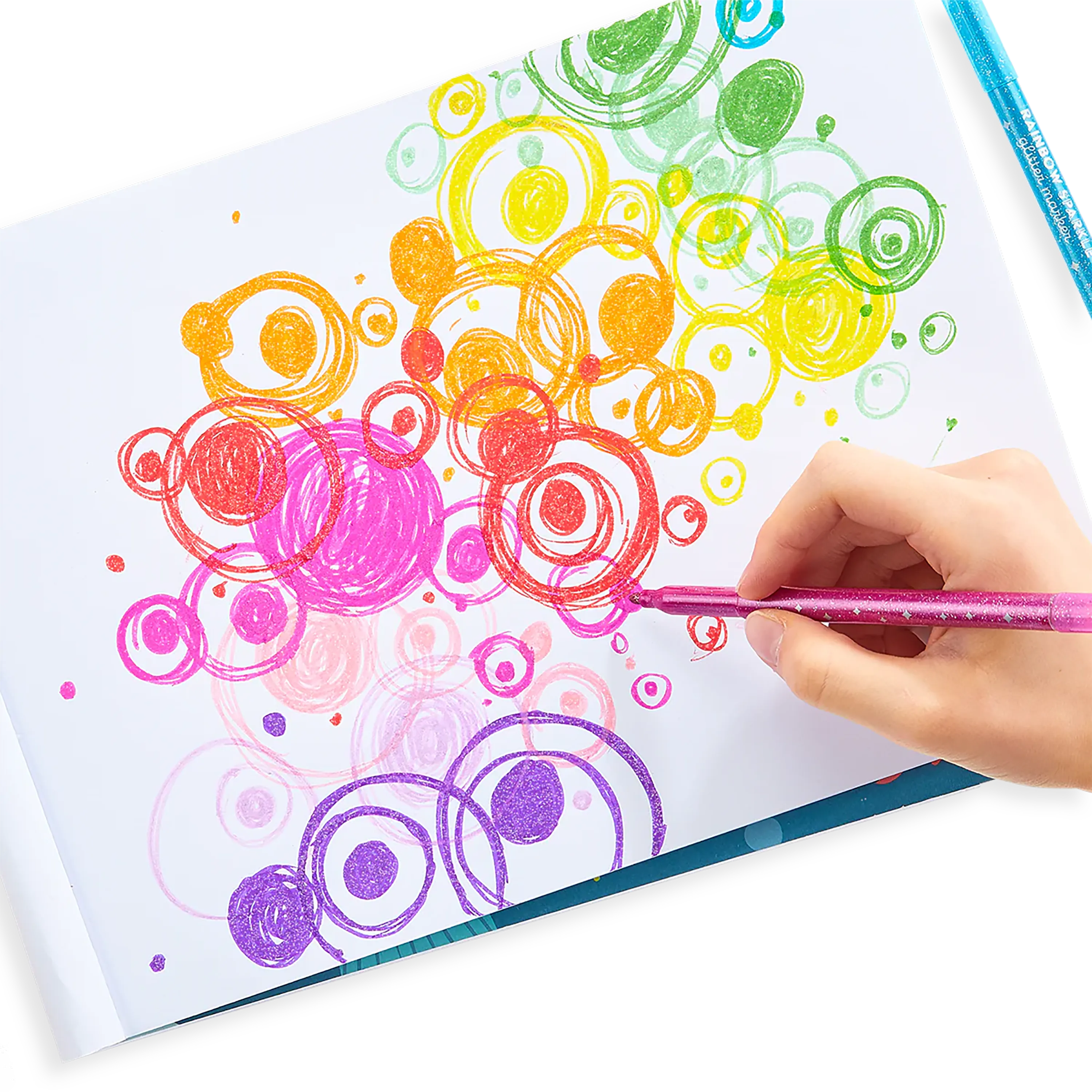 Person coloring rainbowed overlapping circles with OOLY Rainbow Sparkle Glitter Markers