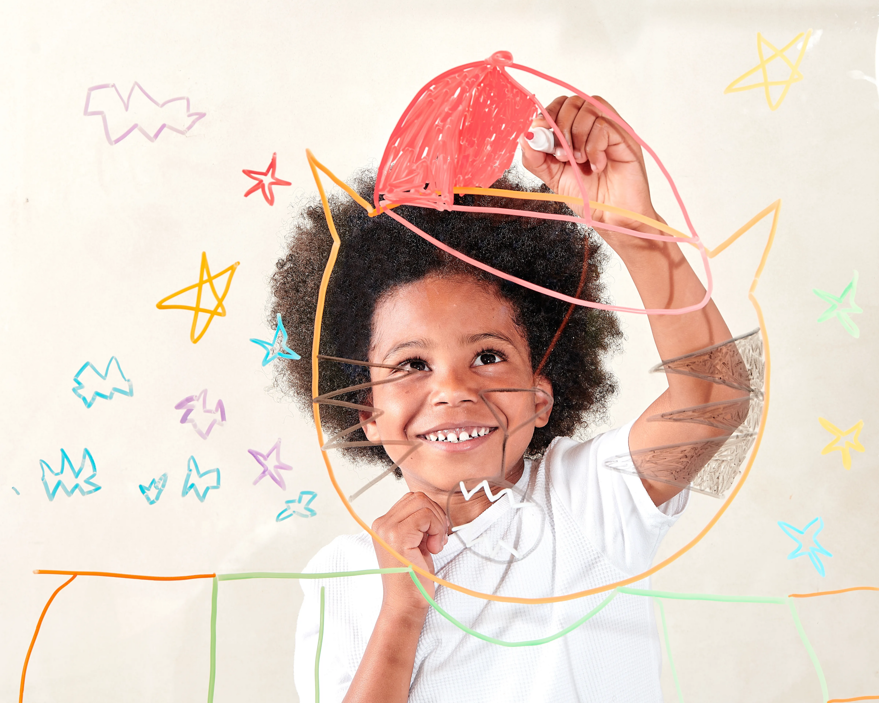 Kid coloring on cat with stars on glass with OOLY Vivid Pop! Water Based Paint Markers