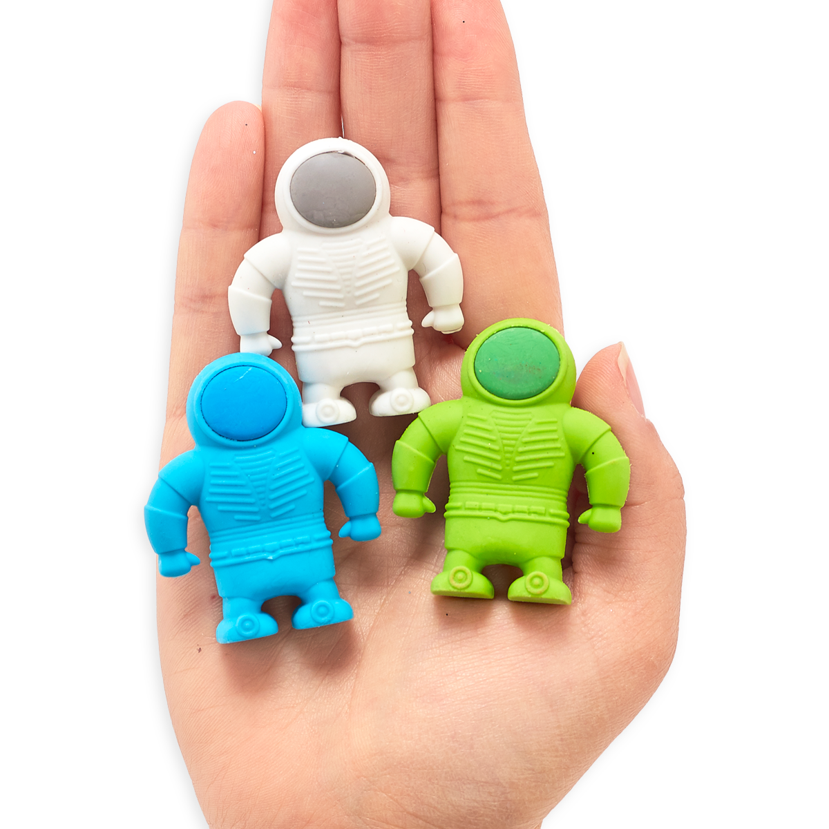 Three OOLY Astronaut erasers in palm of hand
