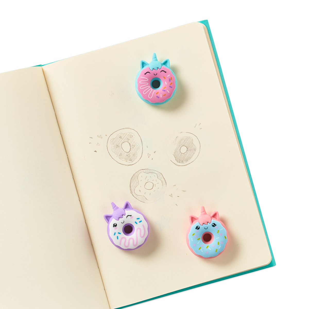 Magic Bakery Unicorn Donut Scented Erasers on a journal