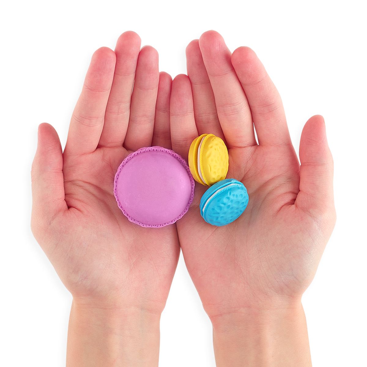 Three Le Macaron Patisserie Scented Erasers in persons hands