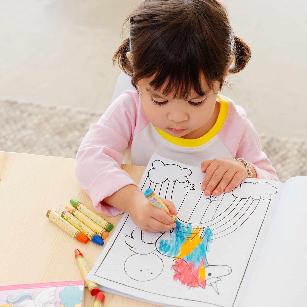 child coloring in an Enchanting Unicorns Coloring Book
