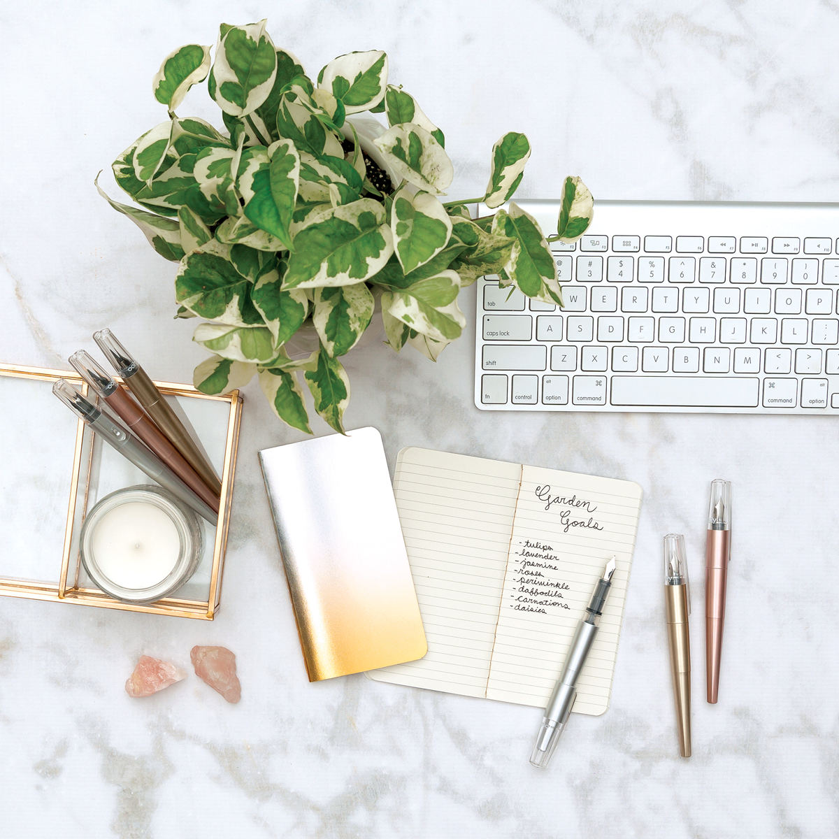 Modern Script fountain pens and pocket notebook on a marble tabletop