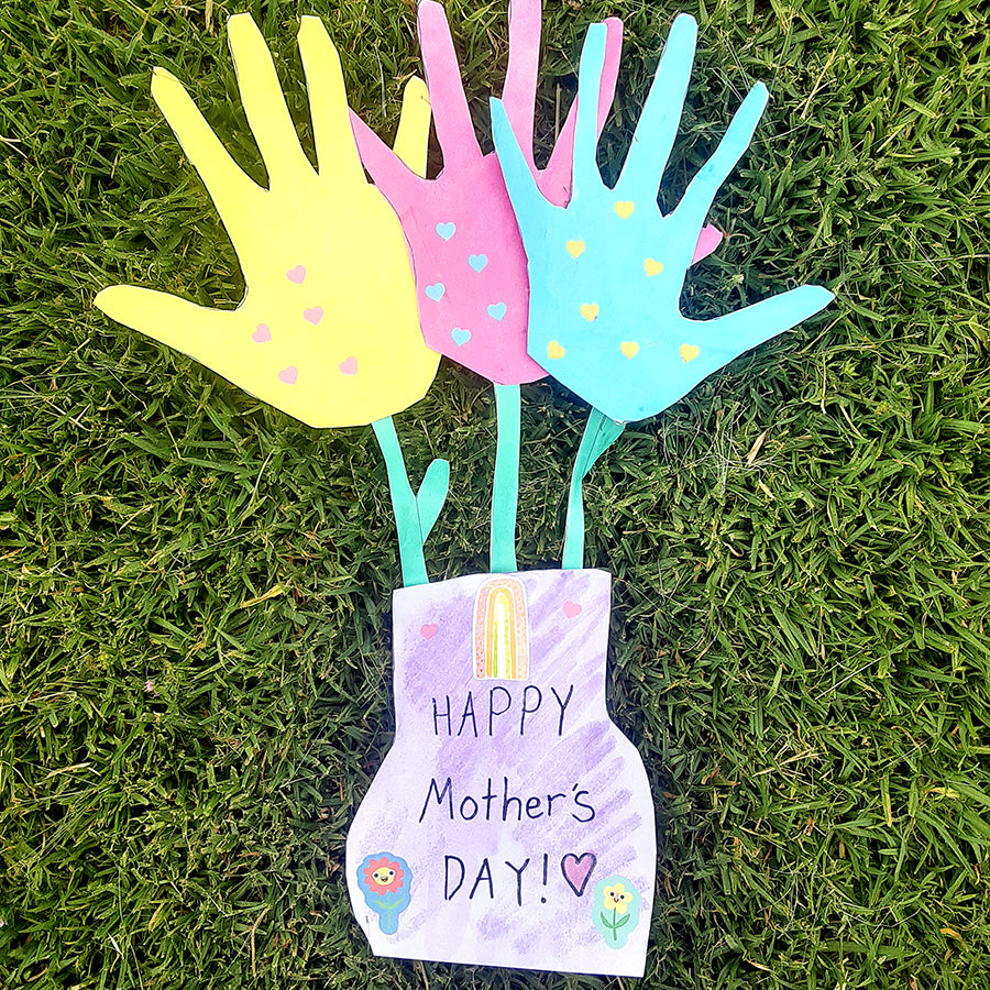 Cut out yellow, pink, and blue hand flowers in colorful paper vase