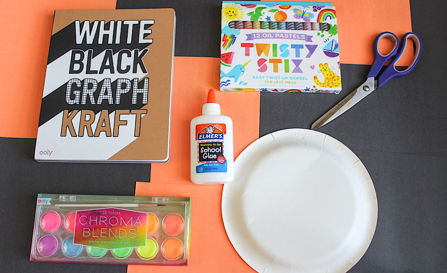 craft supplies on orange and black background