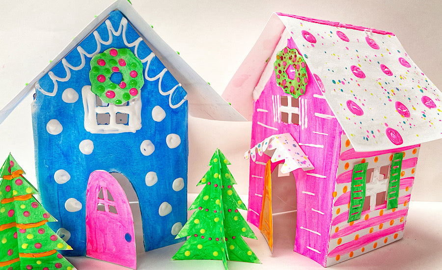 blue and pink paper houses with green trees on white background