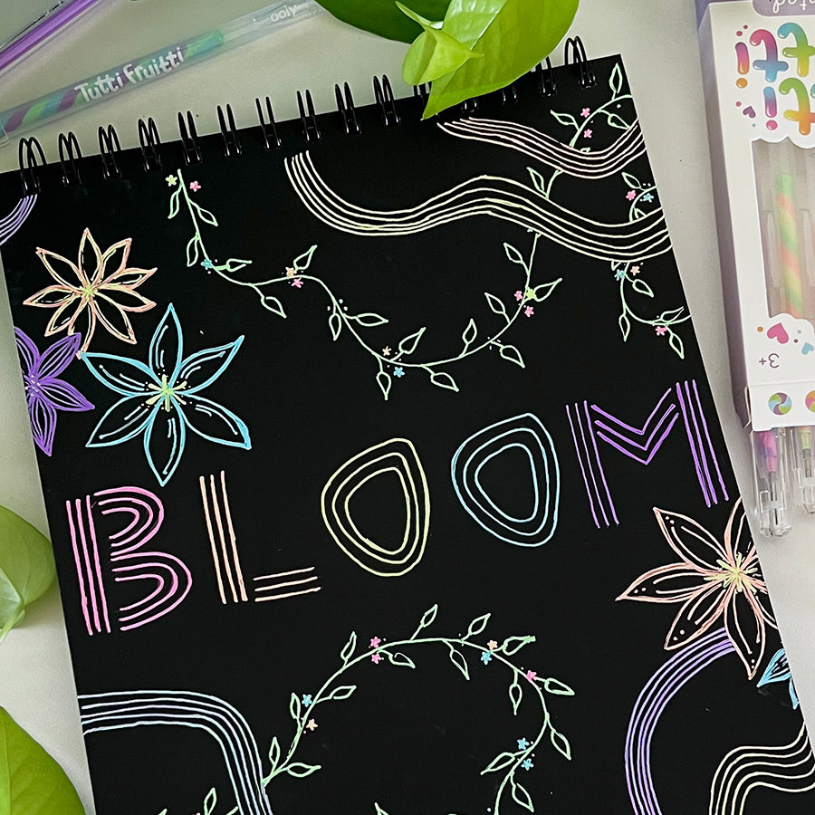 Black sketchbook with colorful line art and flowers