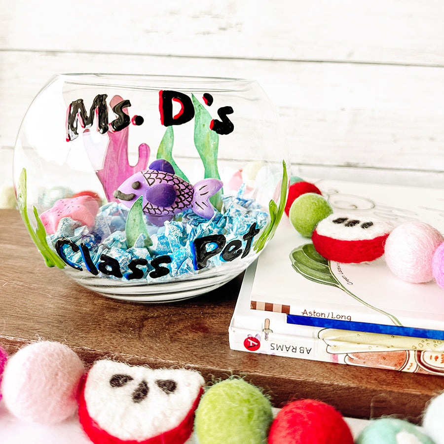 Finished DIY kids craft fishbowl with kids books and toys on a wooden plank