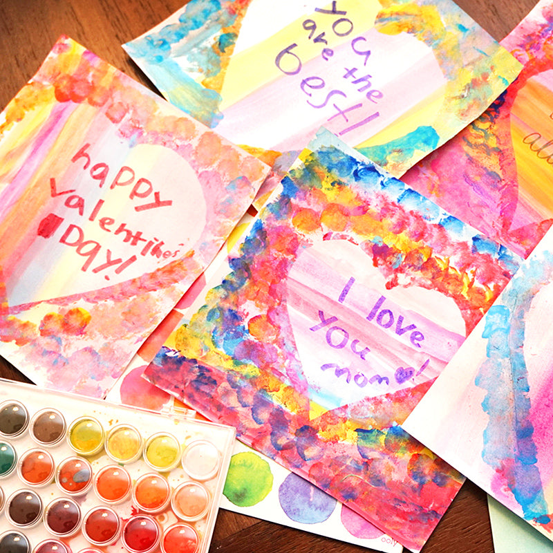 Colorful Valentine's Day Cards on the table with a watercolor set