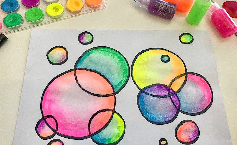 colorful bubbles on white paper with watercolor paint and glitter glue in background