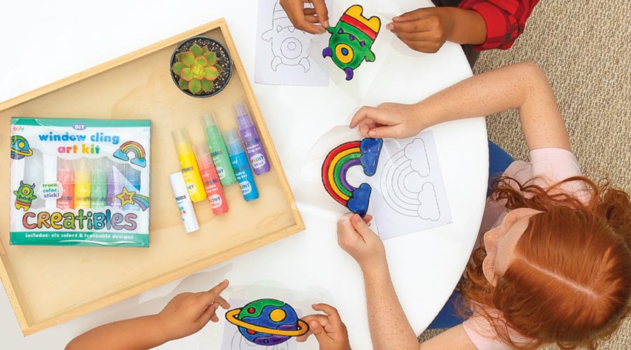 children seated at table using creatibles diy window art clings