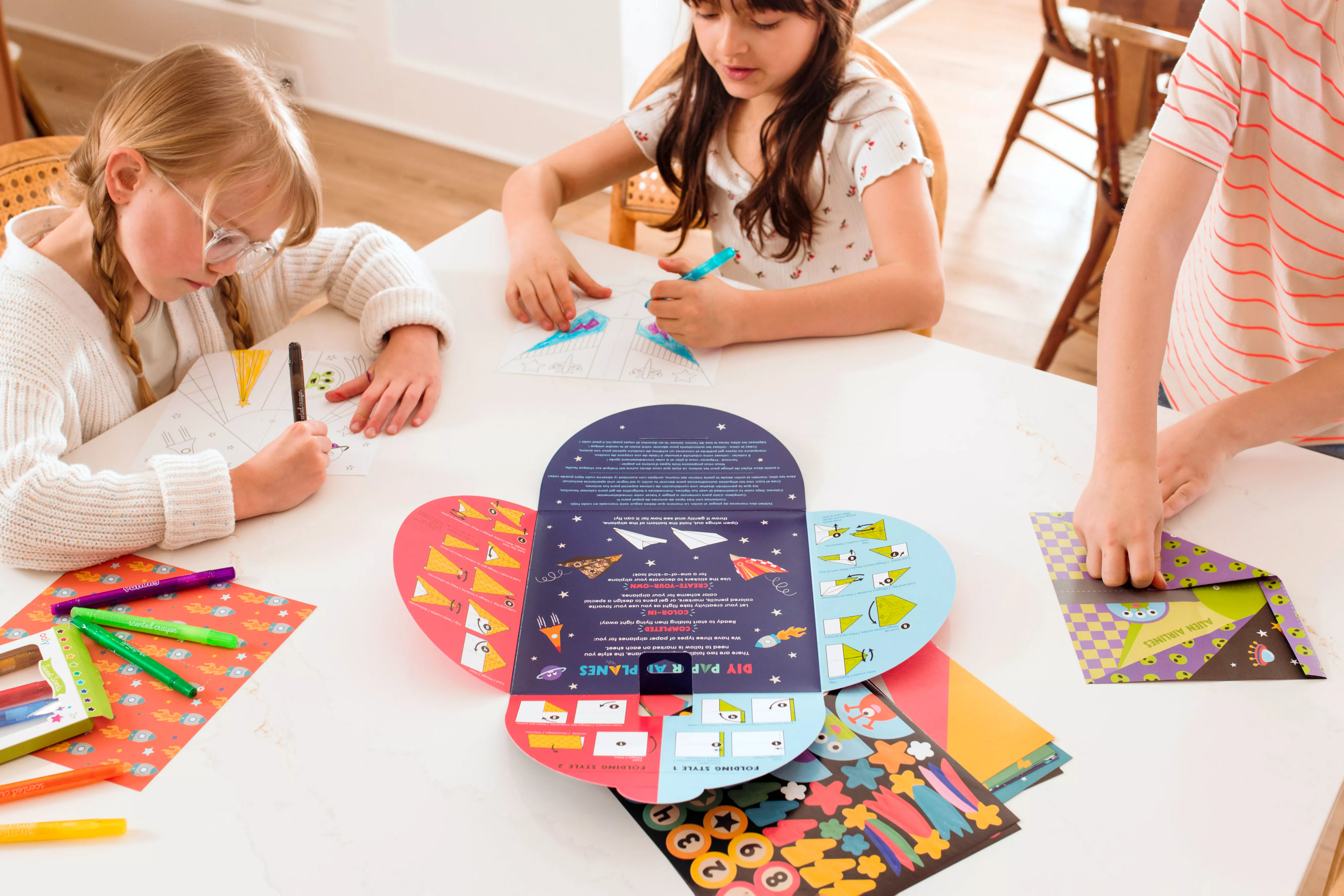 Group of kids coloring pages from OOLY DIY Paper Airplanes Activity Kit