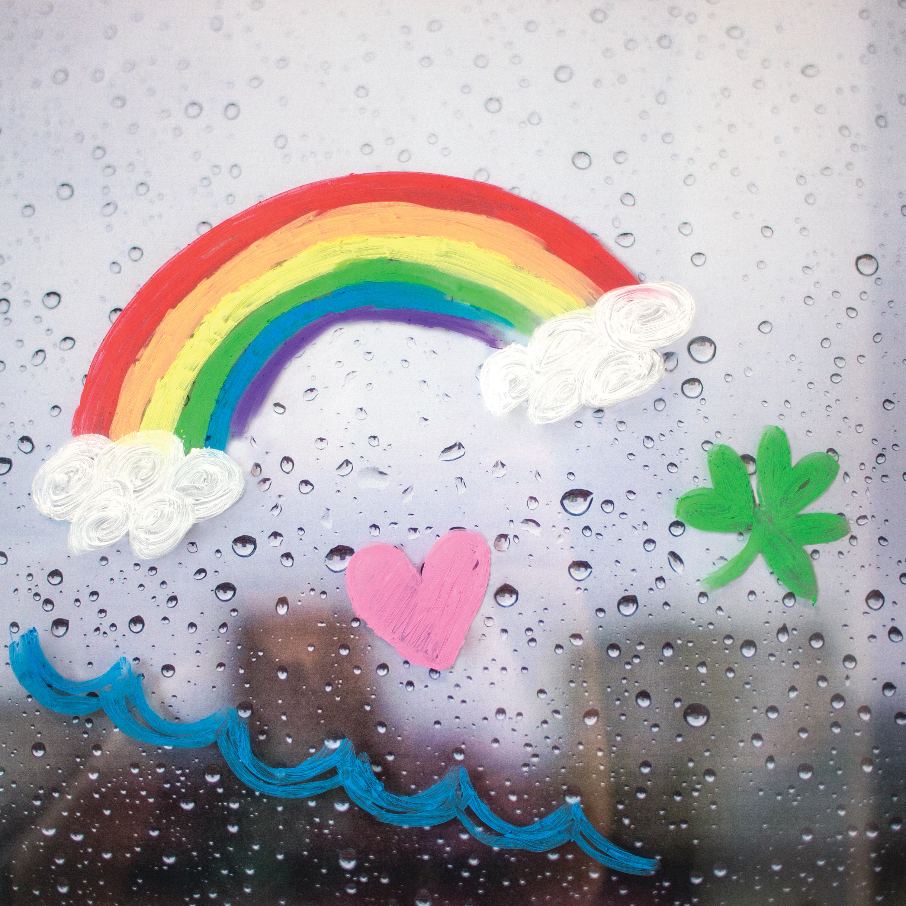 Rainbow art drawn on rainy window with OOLY Rainy Dayz gel crayons