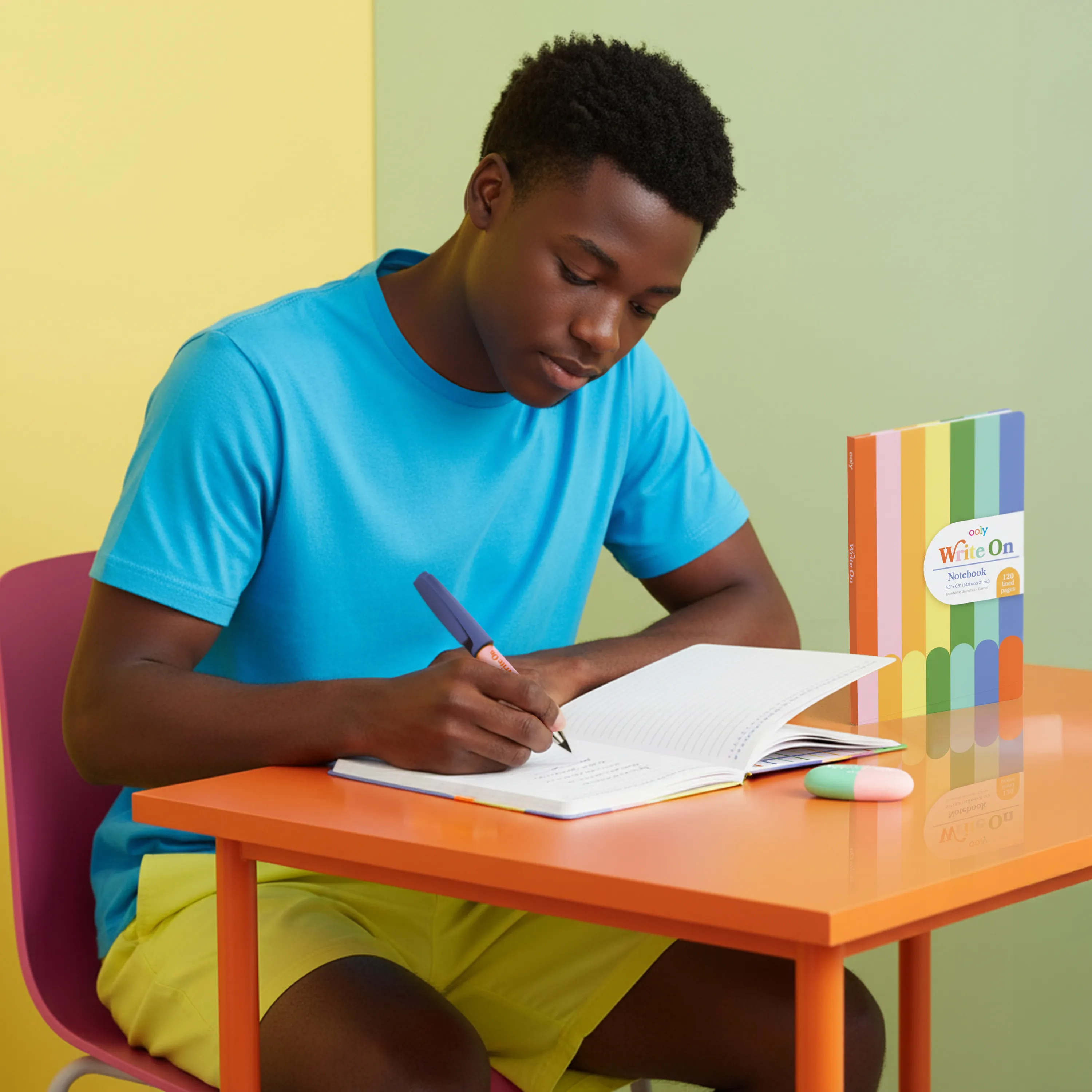 Kid at a desk writing in an OOLY Write On Notebook