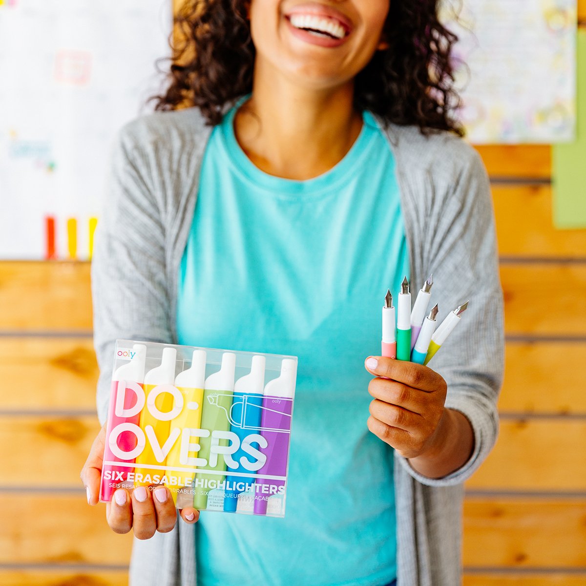 Image of happy teacher holding up Do-Overs Erasable Highlighters