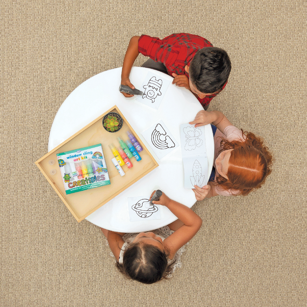 3 kids at a table making window clings with Creatibles DIY Window Cling art kits