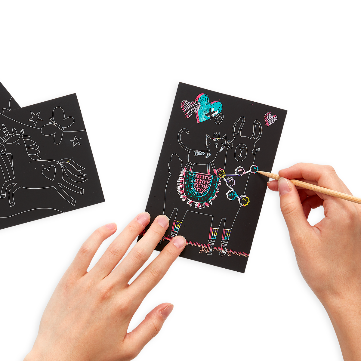 Hands drawing on the Funtastic Friends Scratch and Scribble Mini Scratch Art Kit